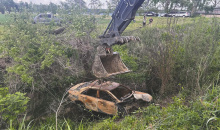 Car suspected to belong to missing teacher is removed from deep ditch north of Lake Providence.