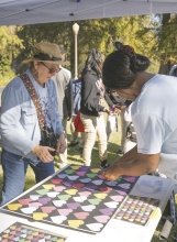 Sara Beth Howard (left) and Ulaila Martin check on a community art project held last fall in collaboration with East Carroll 4-H. LAURA ARVIN