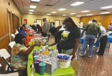 At left, summit attendees visited information tables provided by organizations that support families in East Carroll. At right, some of the organizers of the summit are recognized (from left) Rene Williams, parish clerk of court, Wydette Williams, sheriff, Judge Laurie Brister, Orlando Davis, Office of Juvenile Justice, Judge Angela Claxton, Tommy Morant, East Carroll Parish schools, and Cedric Morales, 6th District Judicial Court FINS office.
