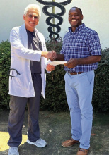 DEBRA HOPKINS Dr. George Fakhre of the Lake Providence Medical Clinic presented General Trass High School Head Coach Toriano Wells with a generous donation to support the athletic department at the school. Wells said that he is grateful for all the support that the community gives the athletes.