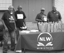Volunteers with NLW ministries hand out wellness kits.