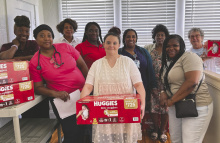 Sorting stock before the diaper giveaway are (from left) Wanda Manning, Dora Smith, Rosie Brown, Brittany Lyons, Meagan Banai, LaKetha Lane, Autrolia Layton, Terrice Newson, and Sara Beth Howard. LAURA ARVIN