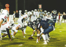 Briarfield offense starts a play. Below, Briarfield cheerleaders support the team TAYLOR HOWARD PHOTOS