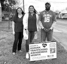 Two representatives of the Children's Advocacy Center stand with Sheriff Wydette Williams to mark Human Trafficking Awareness Month in the parish. DEBRA HOPKINS
