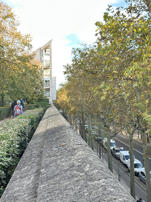 Looking down at a Paris street from the elevated walkway