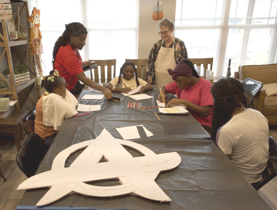Charlene Virgil and Sara Beth Howard watch young artists at work