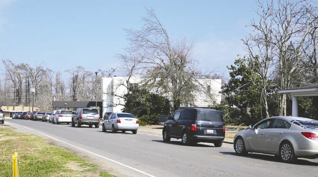 A line snaked around the block from the front of Delta Bank where bank employees served jambalaya and handed out water to all local residents last week.