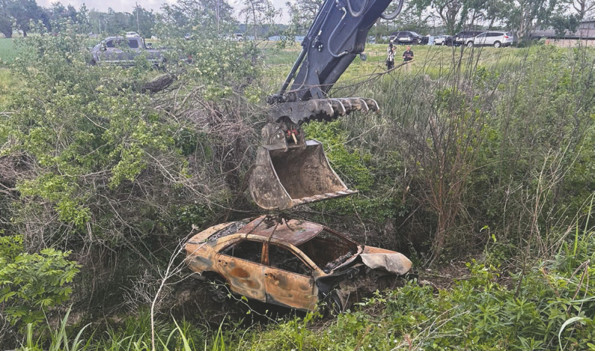 Car suspected to belong to missing teacher is removed from deep ditch north of Lake Providence.