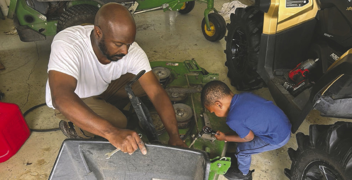 Fred Threats and his grandson 'fix' a piece of equipment