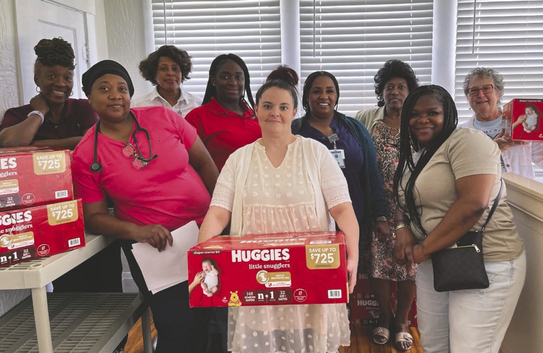 Sorting stock before the diaper giveaway are (from left) Wanda Manning, Dora Smith, Rosie Brown, Brittany Lyons, Meagan Banai, LaKetha Lane, Autrolia Layton, Terrice Newson, and Sara Beth Howard. LAURA ARVIN