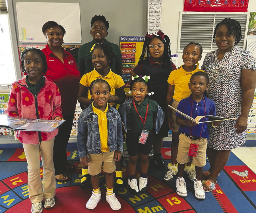 Some past and present participants in the East Carroll Dolly Parton Imagination Library program pose with program supporters Tracy Reynolds (far right), preK teacher at Griffin-Southside Lower and Upper Elementary School, and Cynthia Devereaux-Hampton (back far left) of the East Carroll Parish Library. LAURA ARVIN