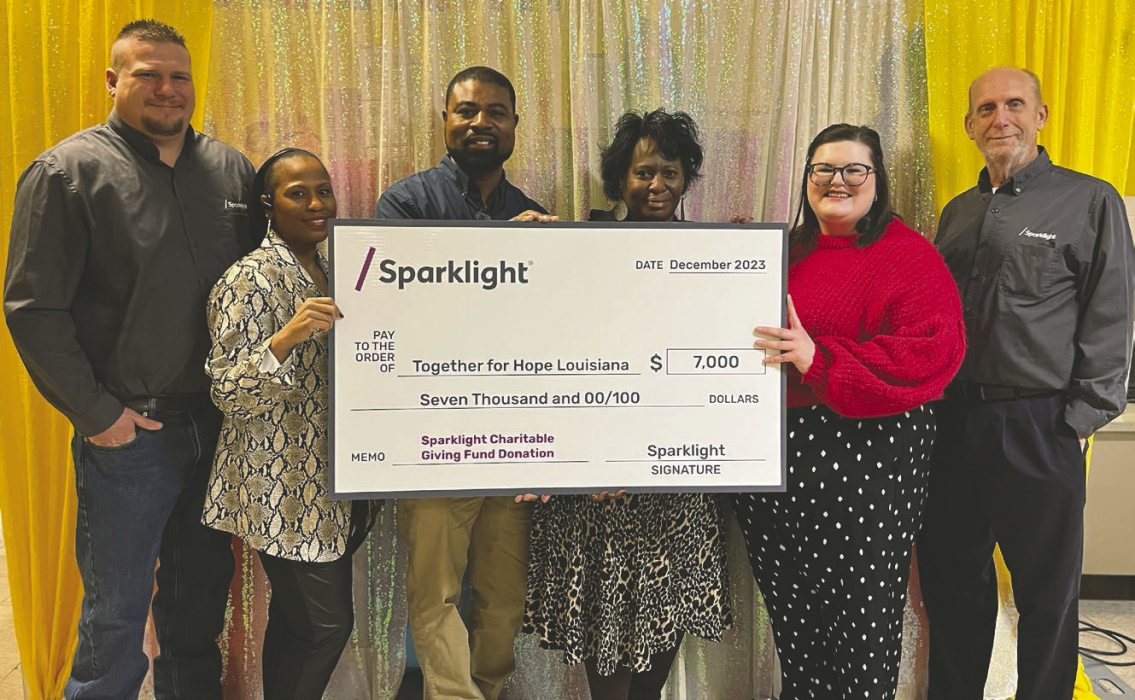 Together for Hope Louisiana received a grant to install a book vending machine at Southside Elementary School, courtesy of Sparklight. According to Leah Lucas, executive director of Together for Hope, a book vending machine works the same way a soft drink machine does, except, in this case, it dispenses books. Children earn credits in a variety of ways, which they can then spend to choose books. The machine will be ordered soon and a ribbon cutting will follow. Pictured at the check presentation are (from l