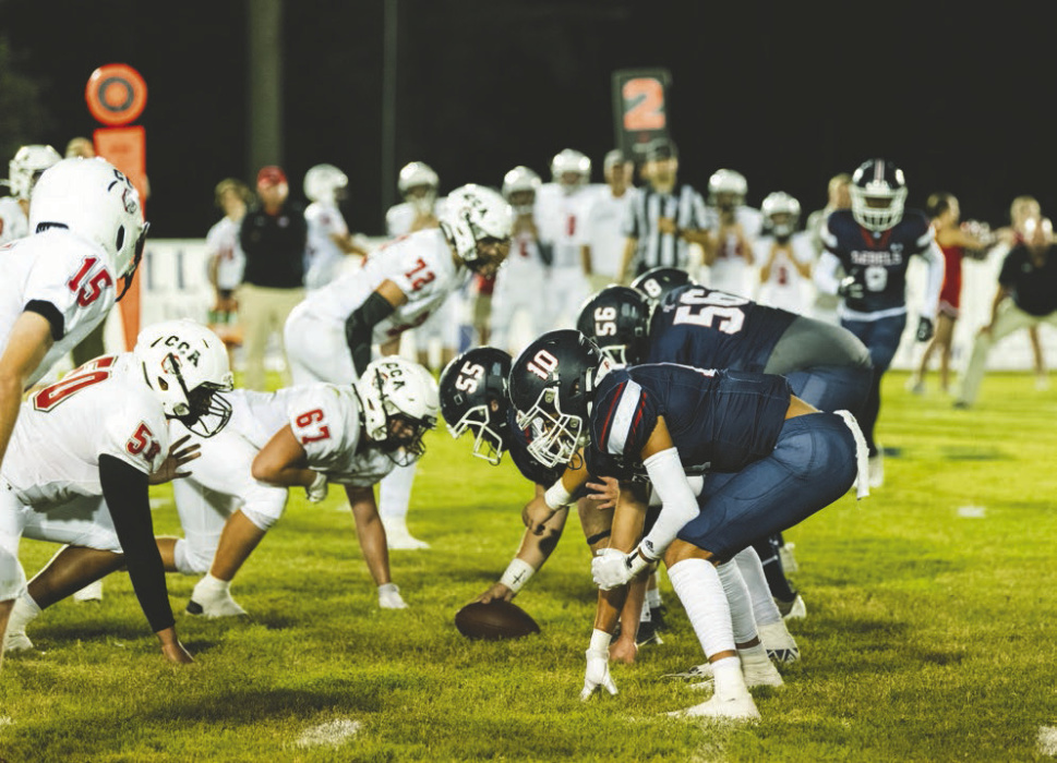 Briarfield offense starts a play. Below, Briarfield cheerleaders support the team TAYLOR HOWARD PHOTOS